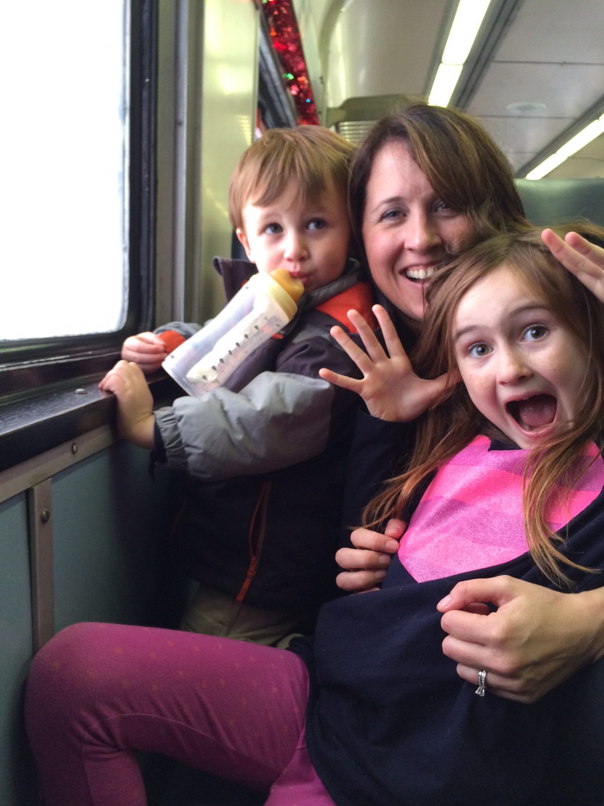 a woman and two children on a train