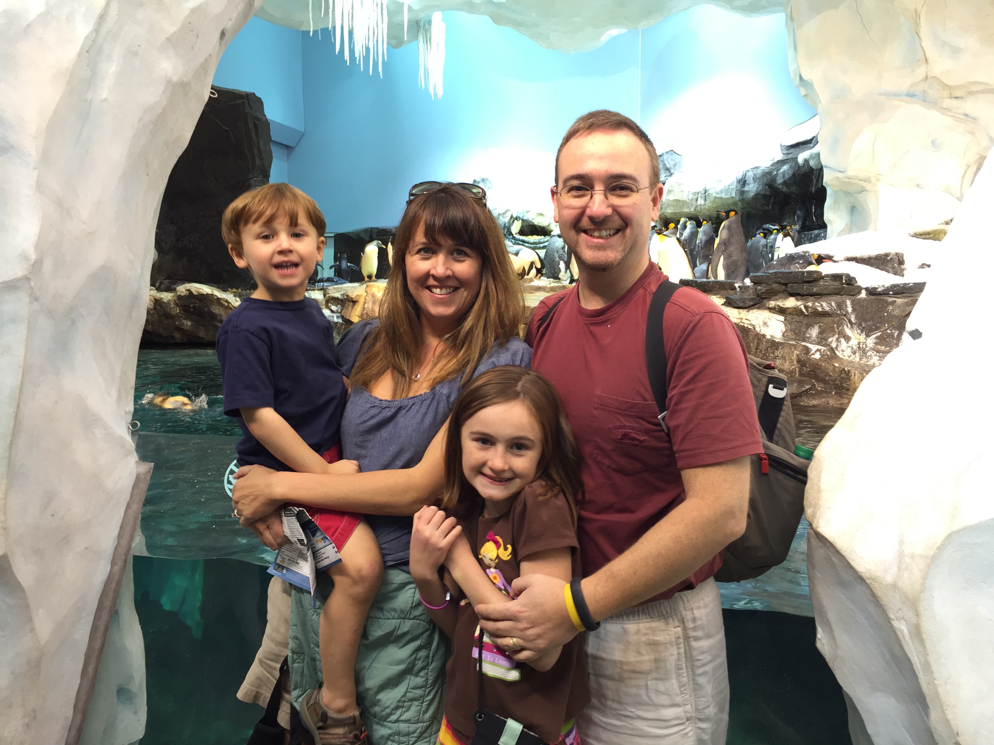 a man and woman with two children in an ice cave