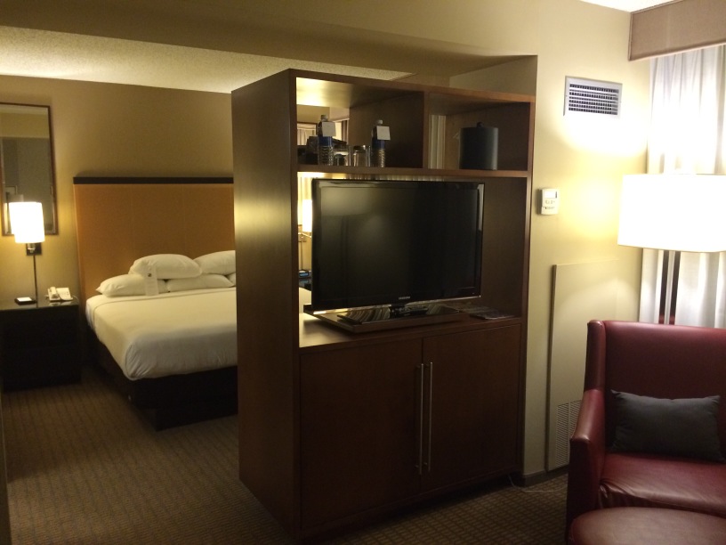 a room with a tv and a bed