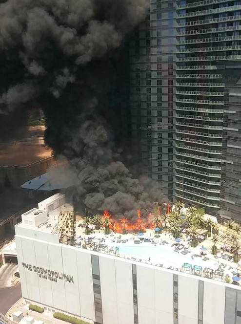 a building on fire with black smoke coming out of it