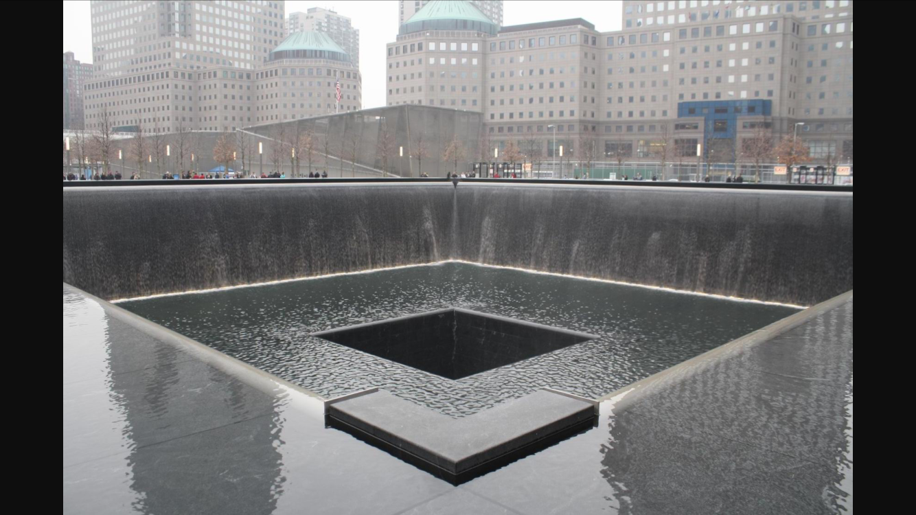 a water fountain with a square in the middle with National September 11 Memorial & Museum in the background
