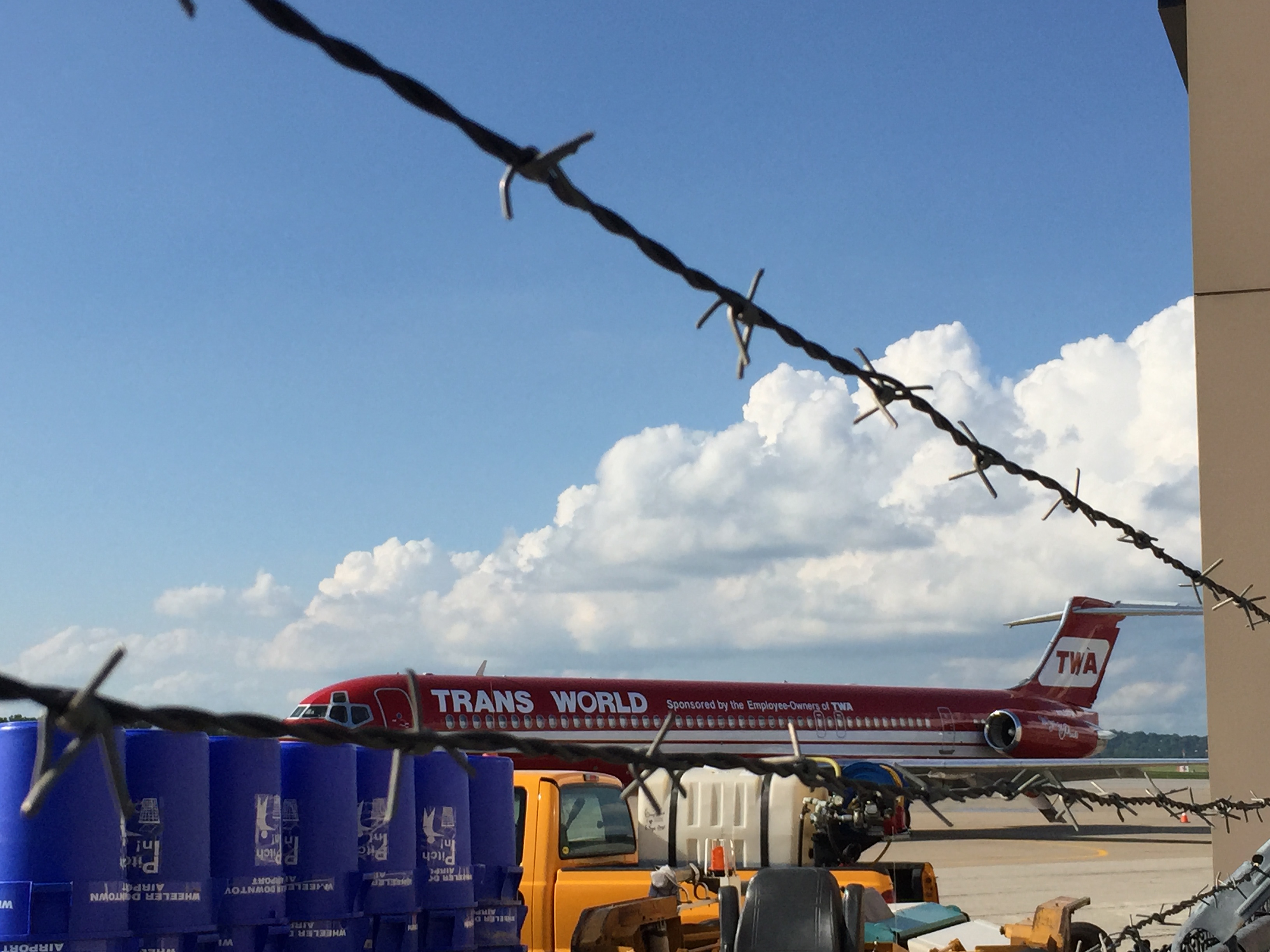 a red airplane parked on a tarmac