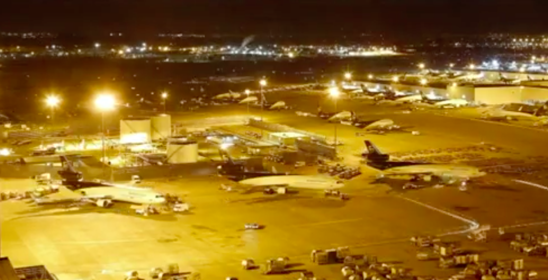 an airport with airplanes parked at night