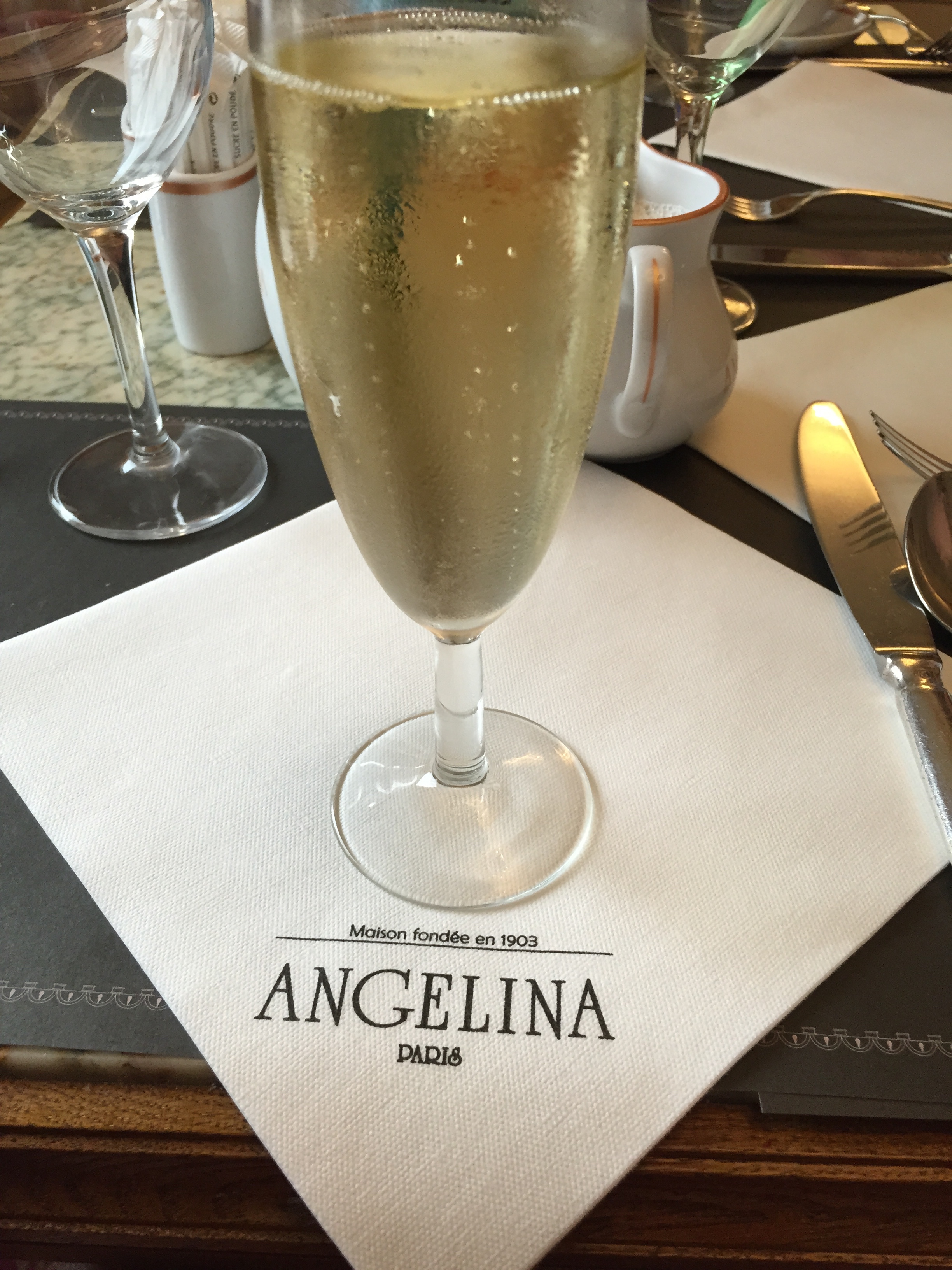 a glass of champagne on a napkin
