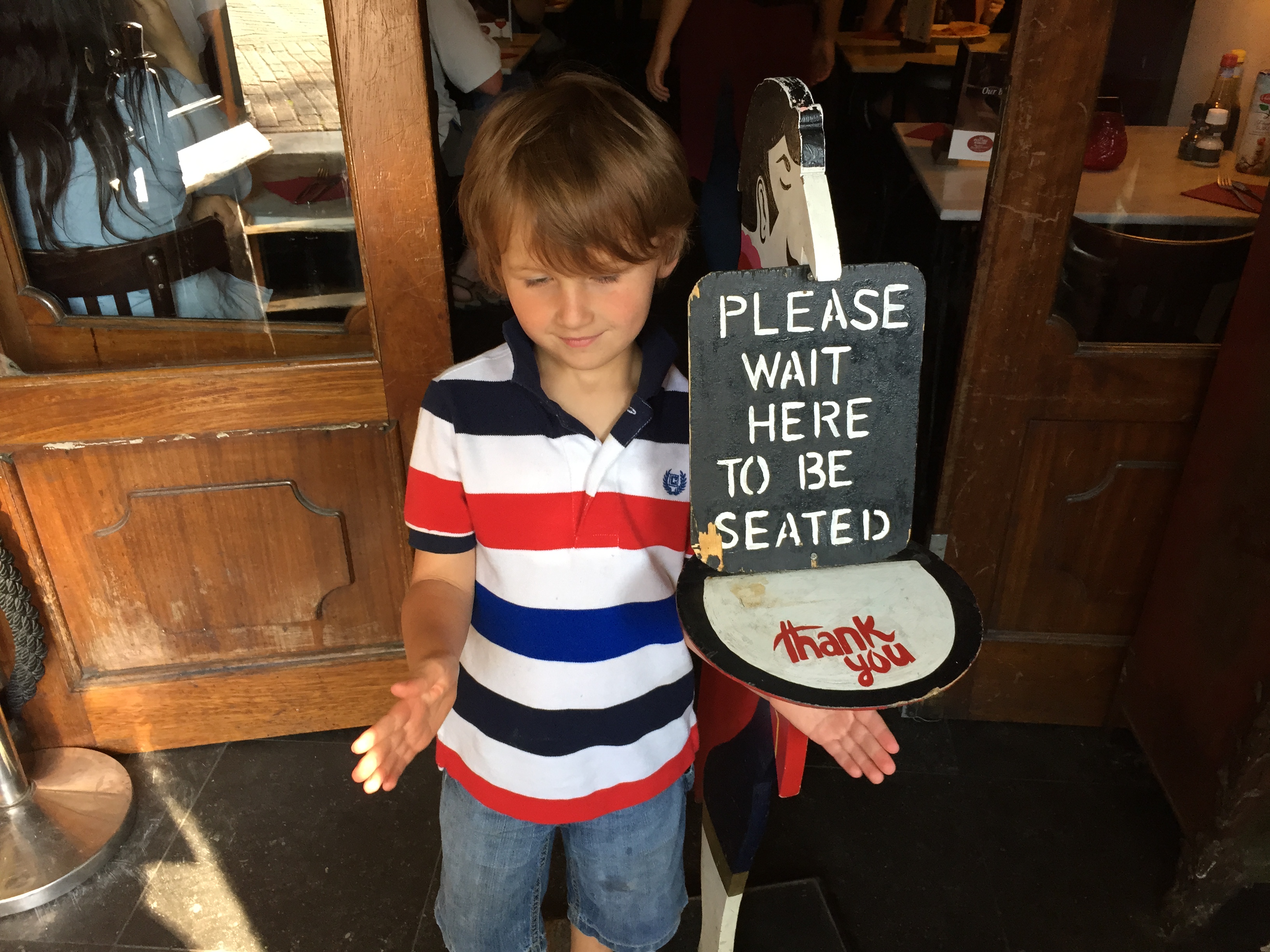 a boy holding a sign