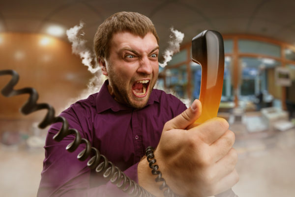 a man holding a telephone