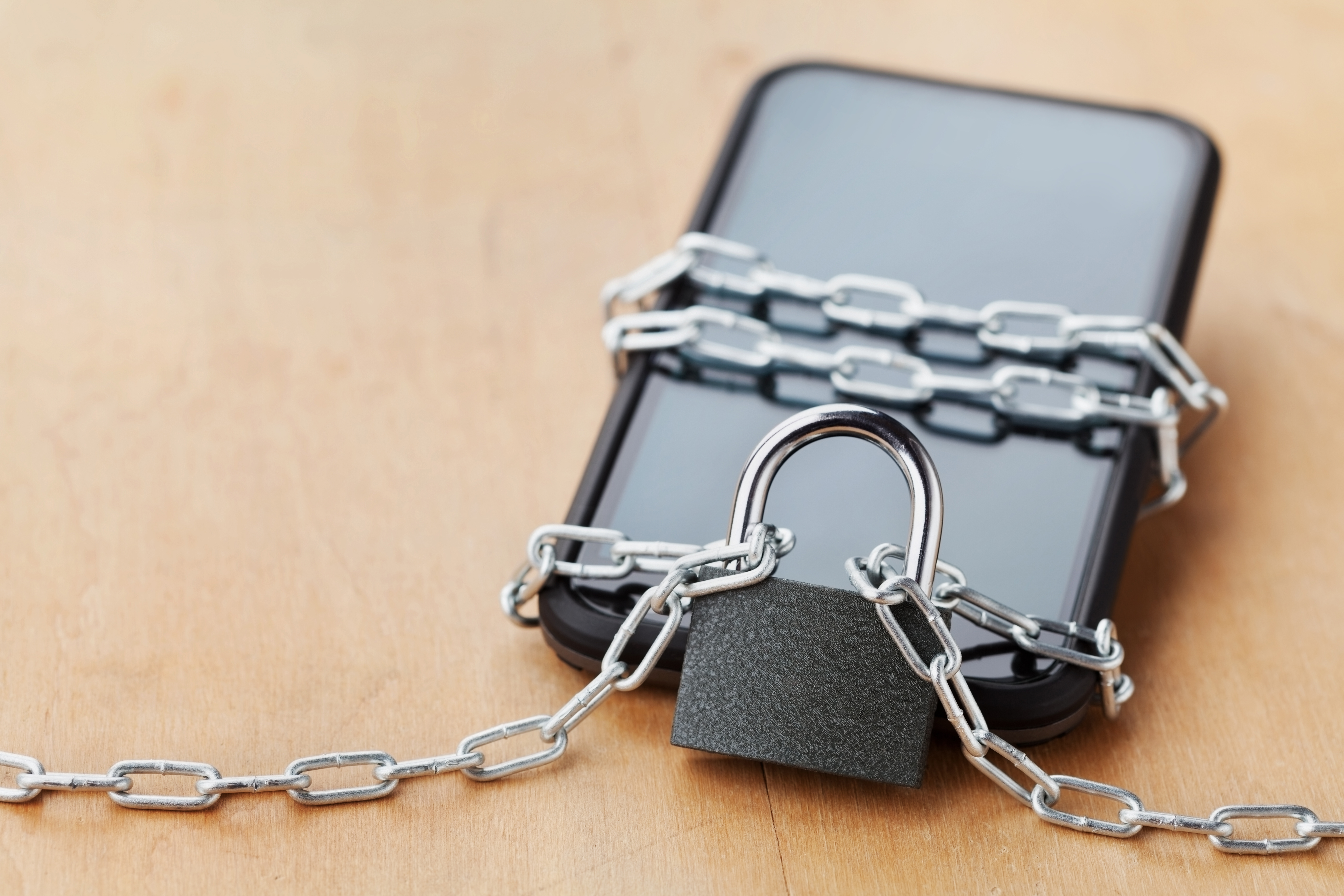 a cell phone with chain and padlock