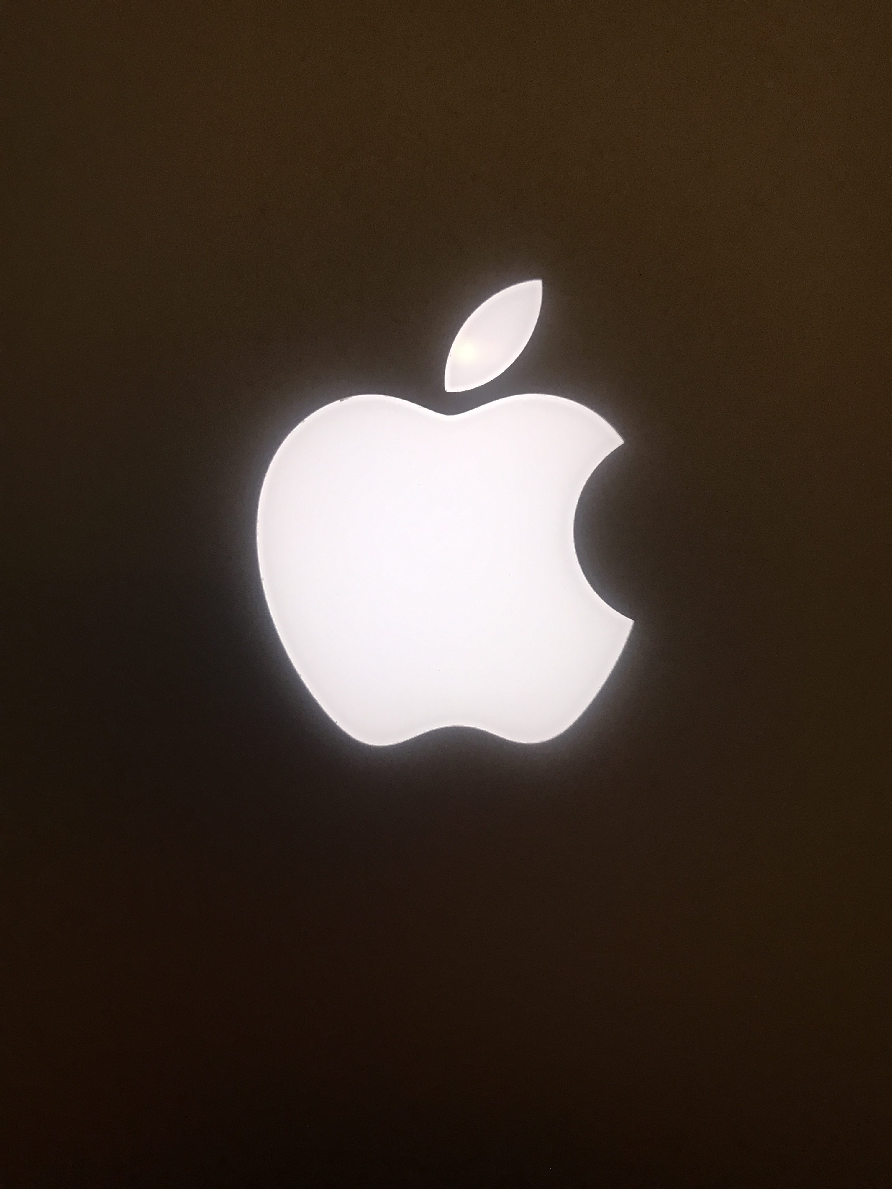 a white apple logo on a black background