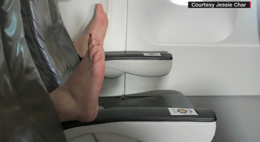 a person's feet on a plane