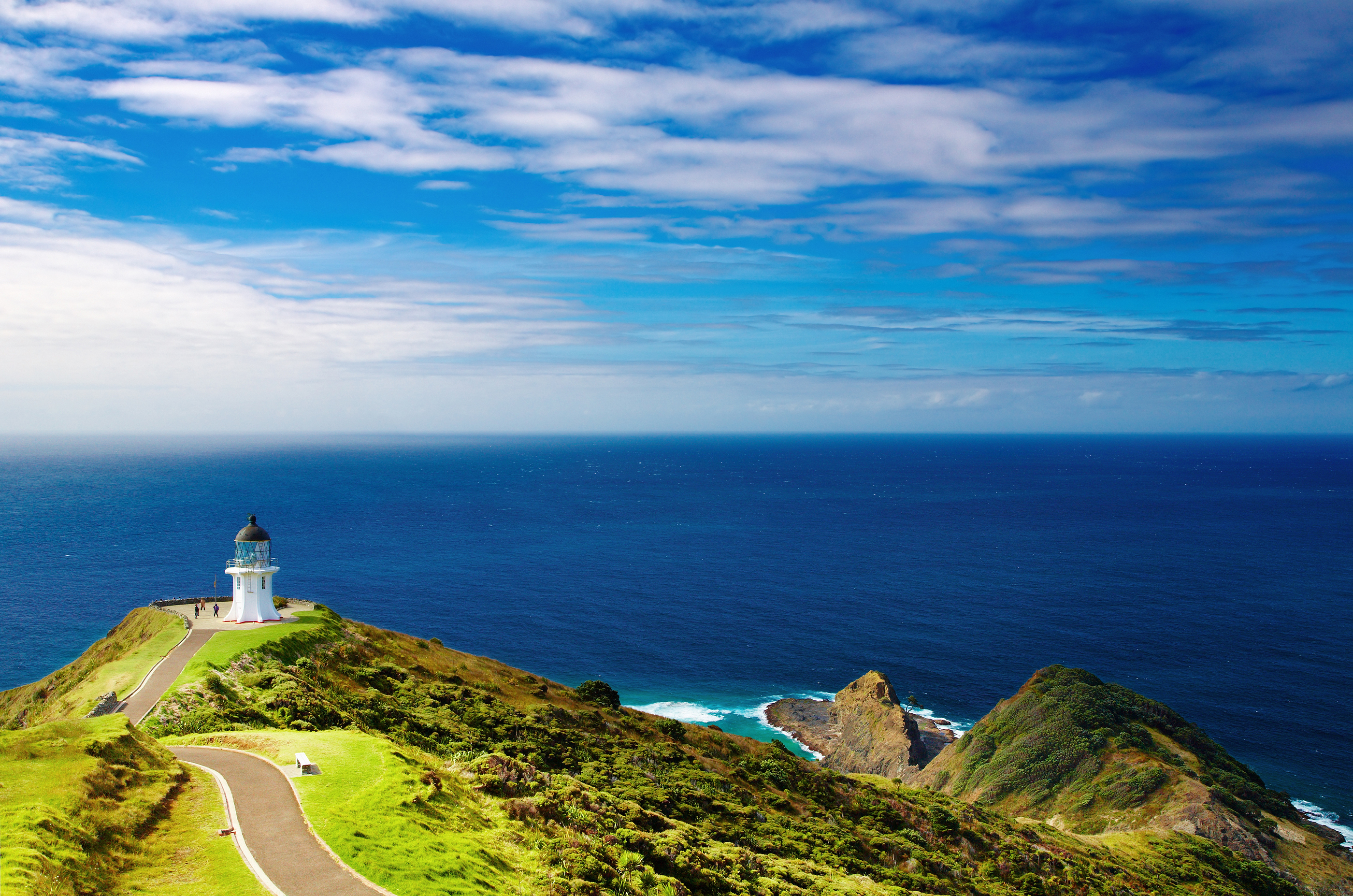 a lighthouse on a hill overlooking the ocean