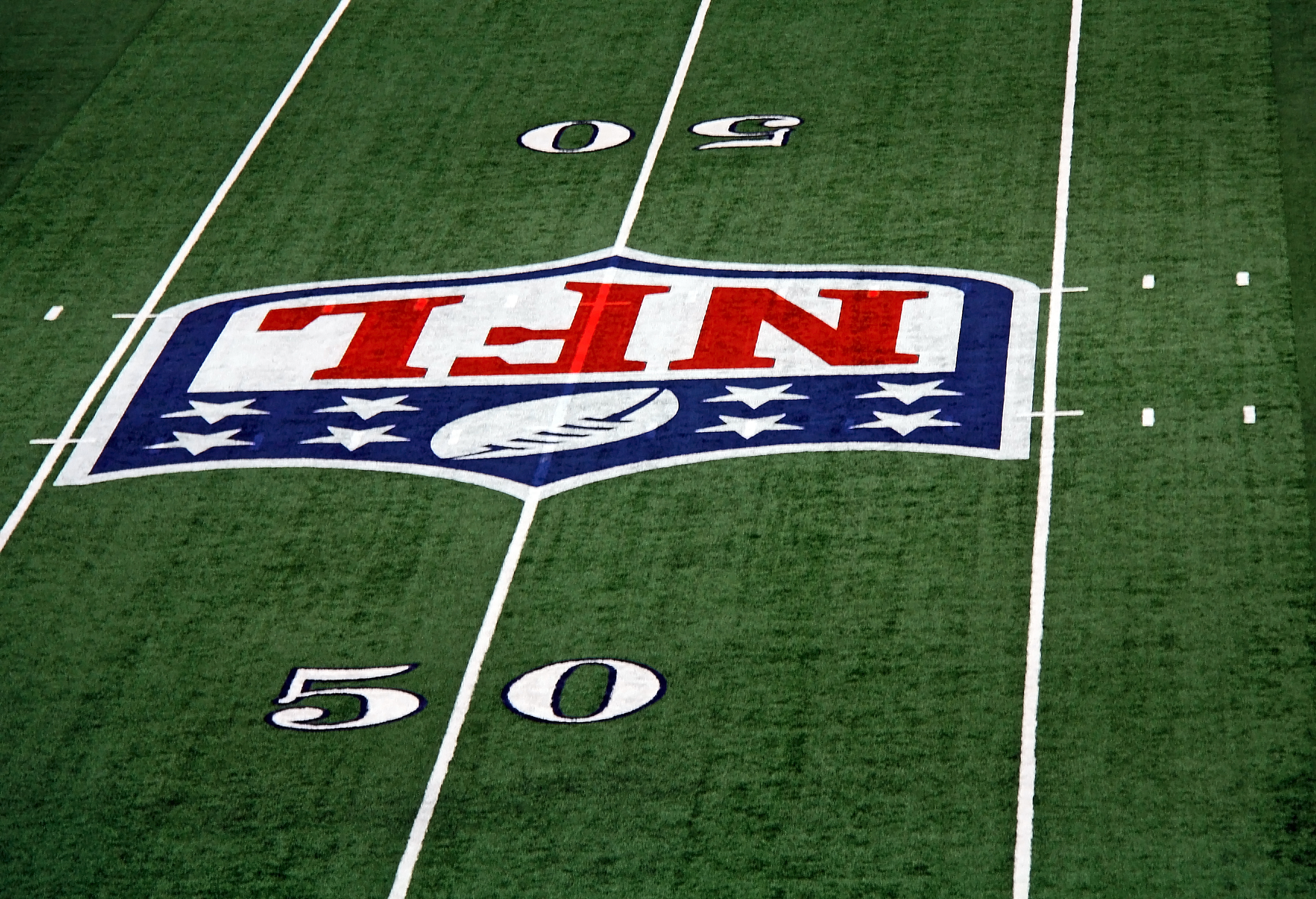 a football field with numbers and logo