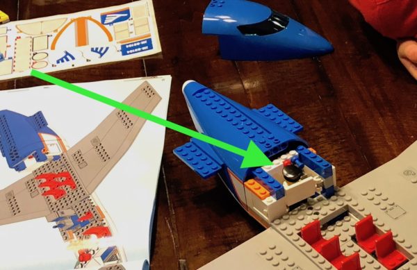 a toy plane with instructions and instructions on a table