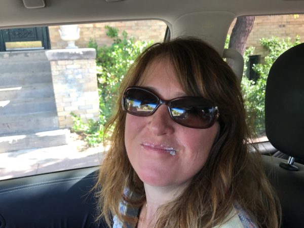 a woman in sunglasses in a car