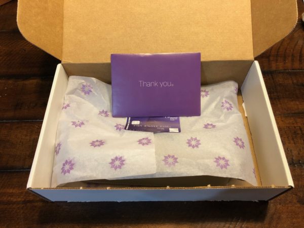 a box with a purple card and a purple envelope