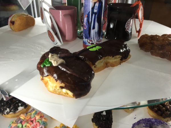 a chocolate covered doughnut on a table