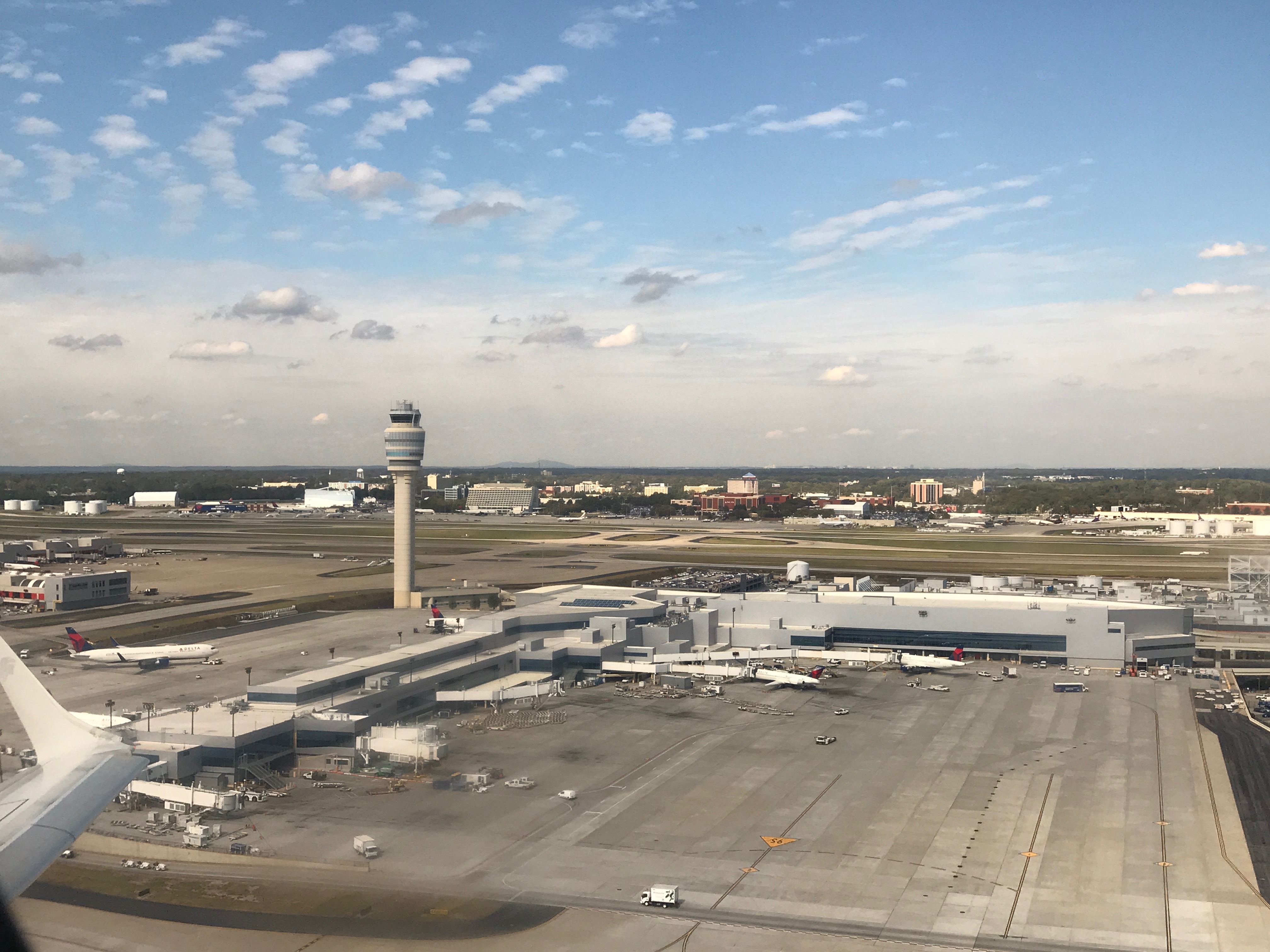 an airport with a tower and buildings