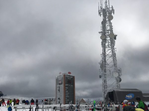 a large tower with many antennas