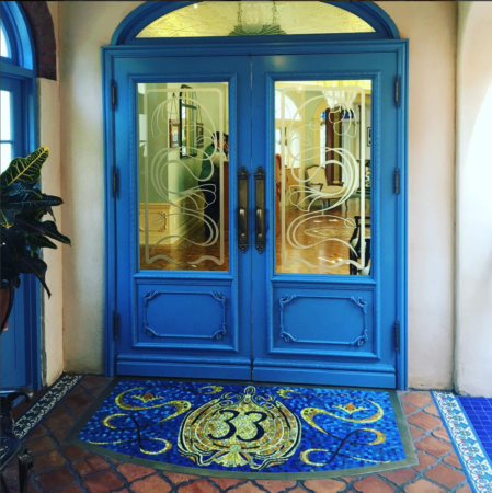 a blue double doors with glass panels