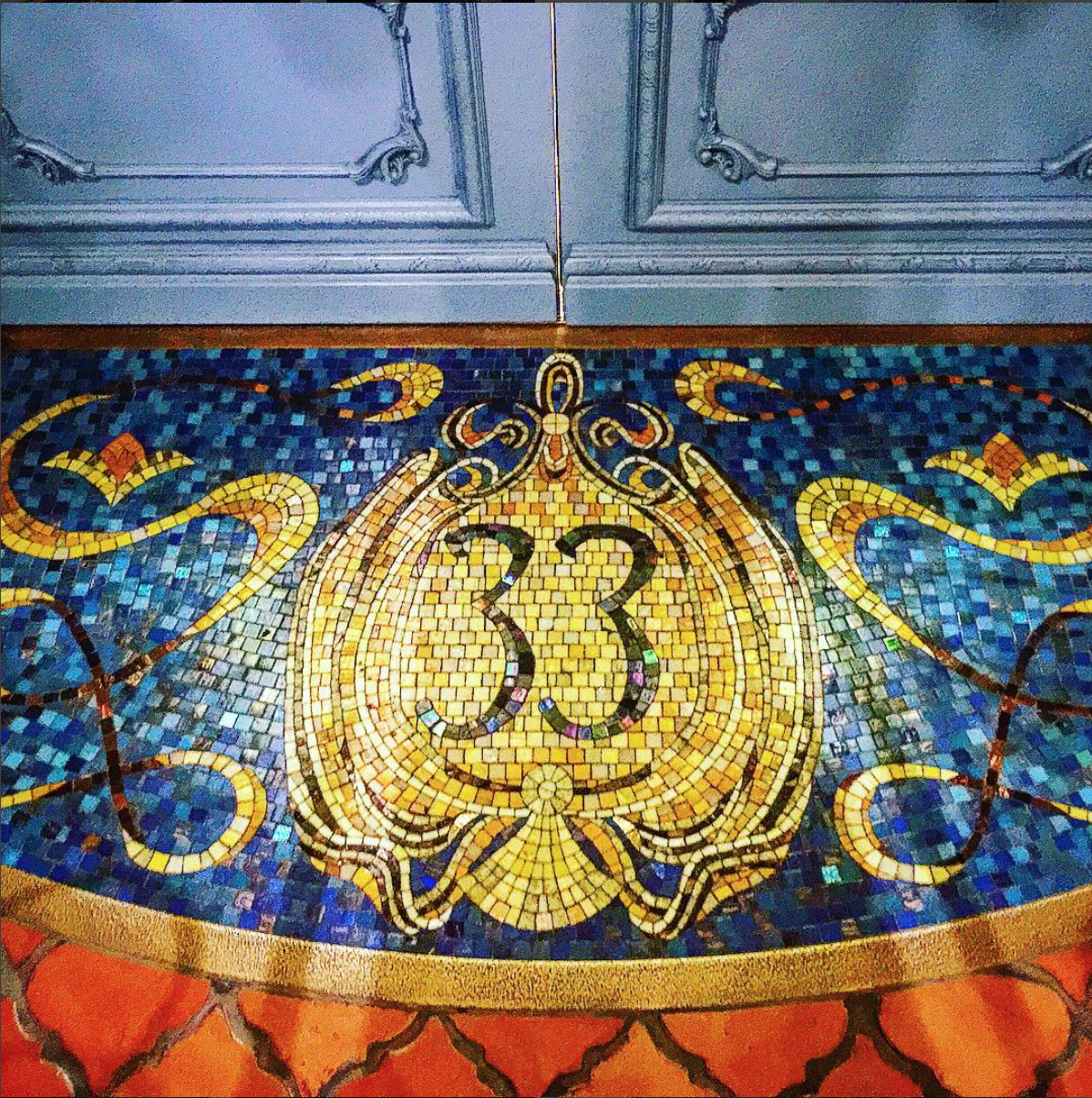 a mosaic floor with a number on it