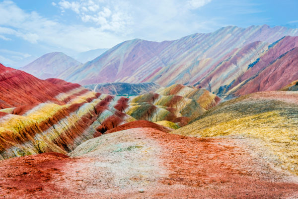 a colorful mountains with blue sky