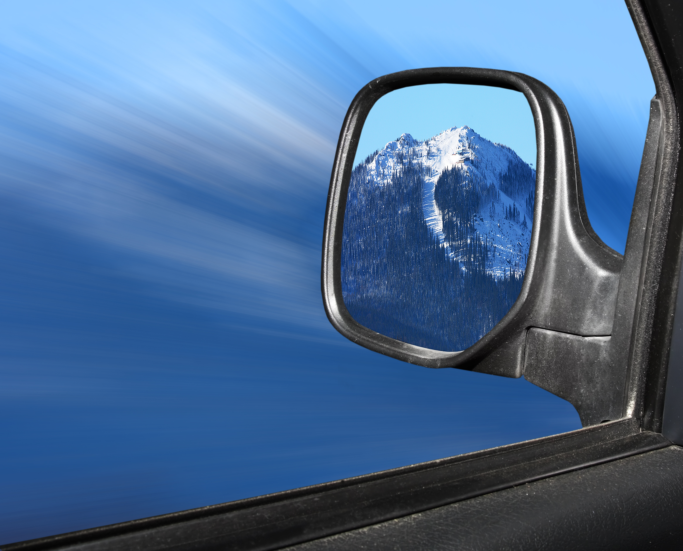 a side view mirror of a mountain