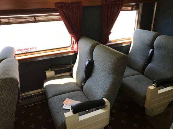a two grey chairs in a train