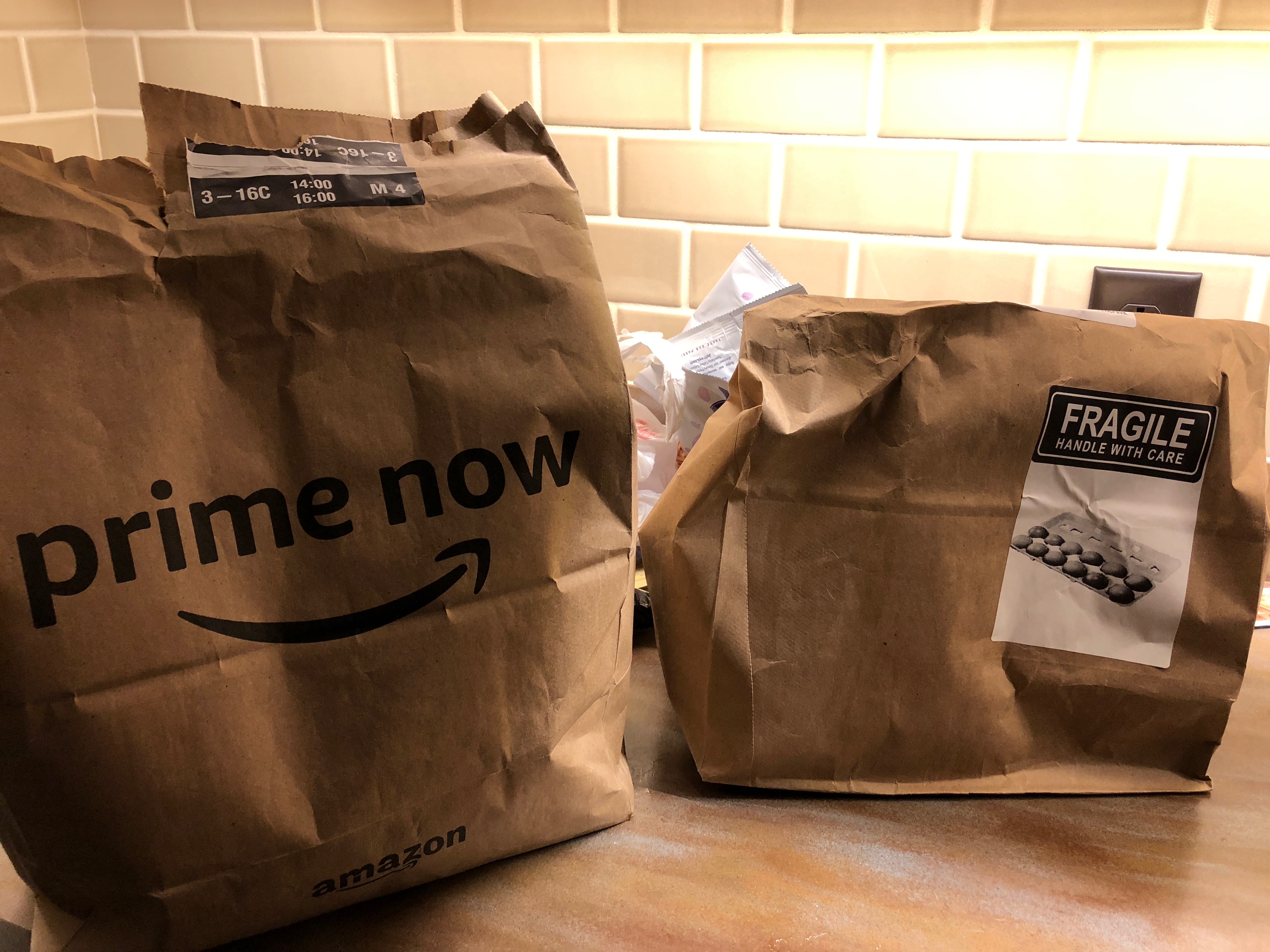 two brown bags with black text on them