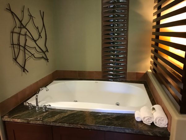 a bathtub with towels on the counter