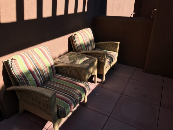 a chair and table on a patio