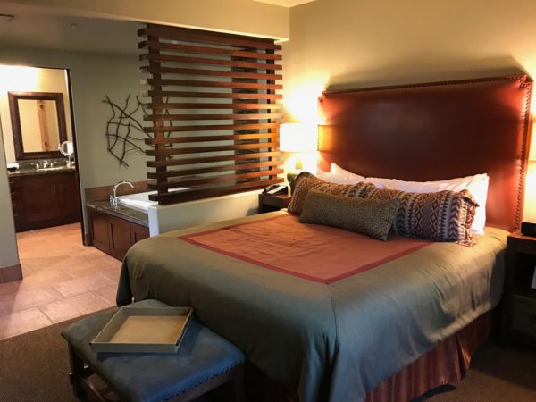 a bed with a brown headboard in a hotel room