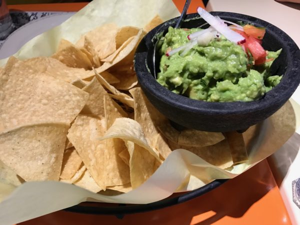 a bowl of guacamole and chips