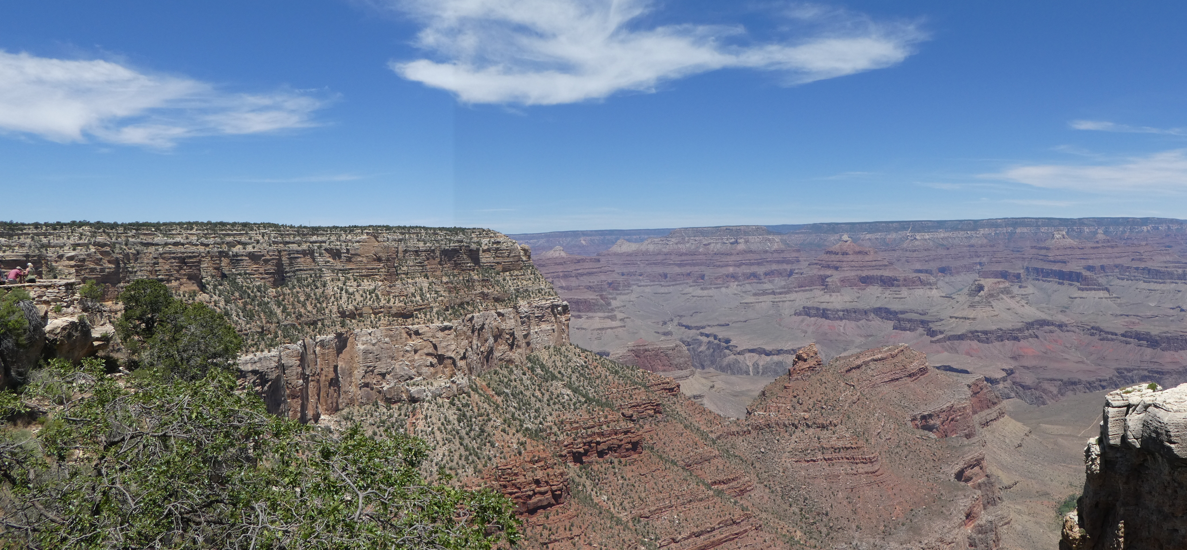a large canyon with a blue sky