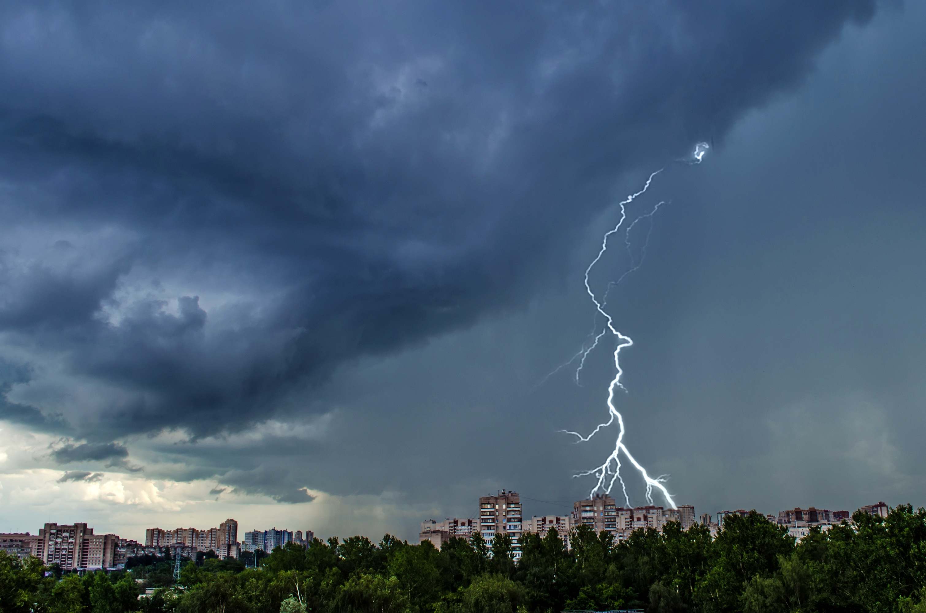 lightning lighting bolt in the sky over a city