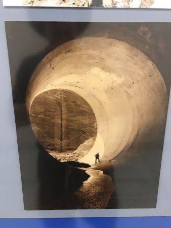 a poster of a man walking through a tunnel