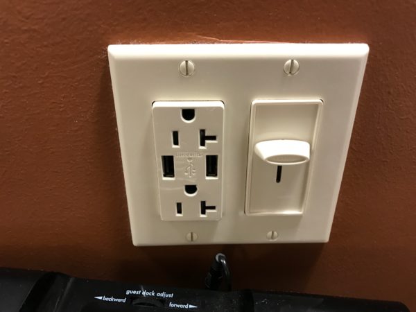 a white outlet with a plug and a key