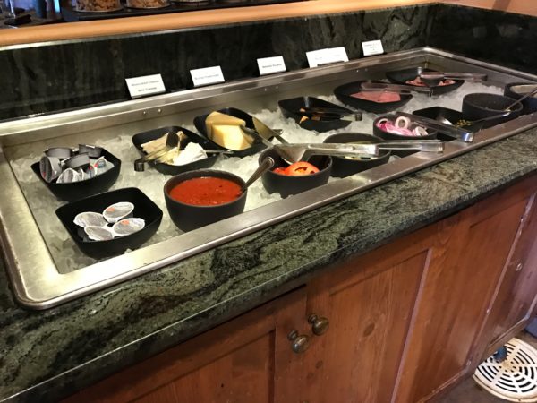 a buffet line with different food items on it