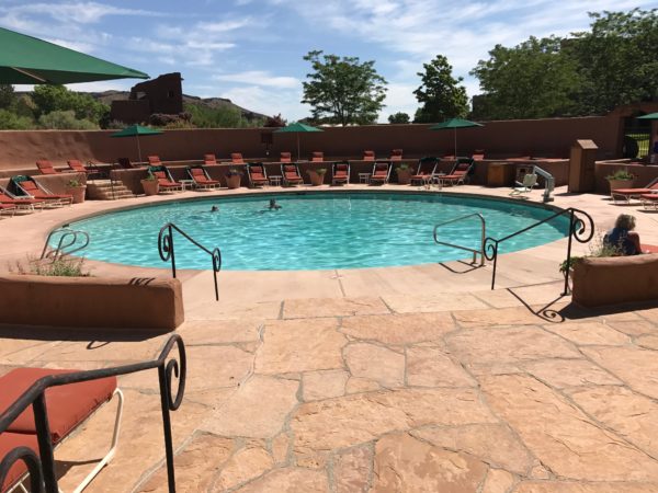 a pool with chairs and umbrellas