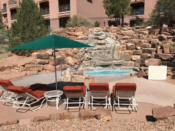 a pool with chairs and umbrella