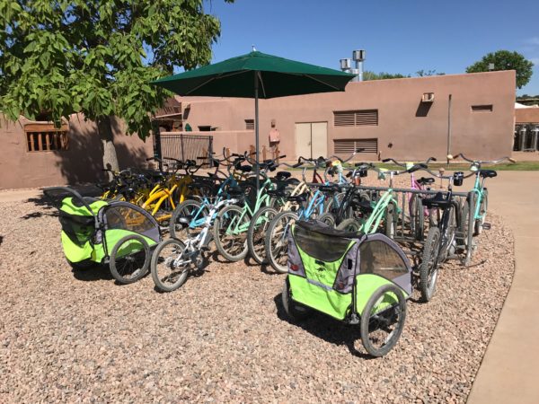 a group of bicycles parked on gravel