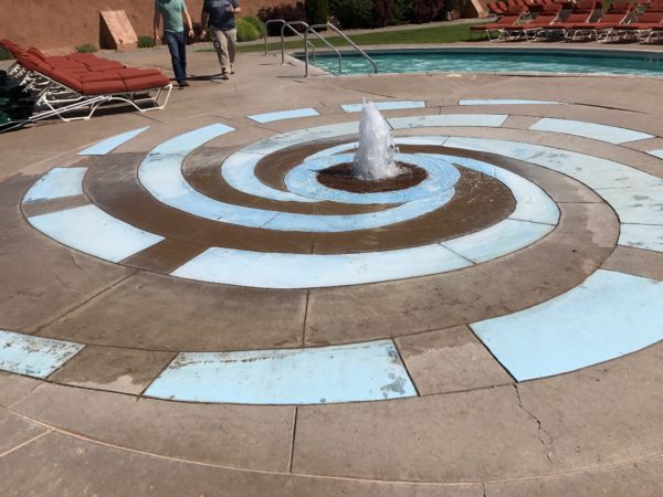 a pool with a water fountain