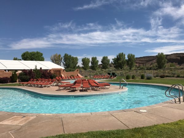 a pool with lounge chairs around it