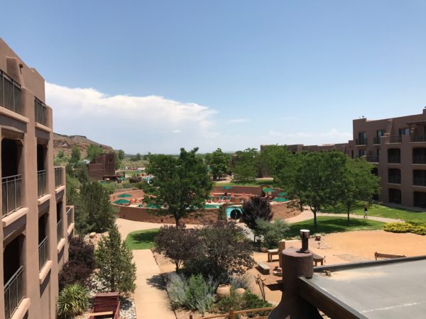 a view of a courtyard with trees and buildings