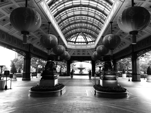 a black and white photo of a large indoor courtyard