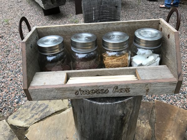 a wooden box with jars and crackers