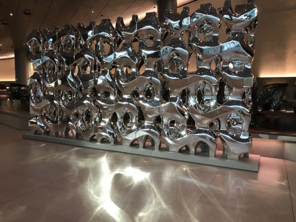 a large silver sculpture in a room