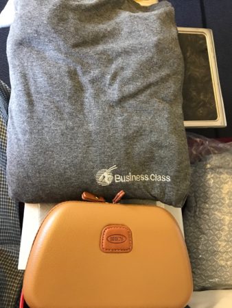 a grey shirt and brown case