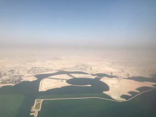 an aerial view of a land with a body of water
