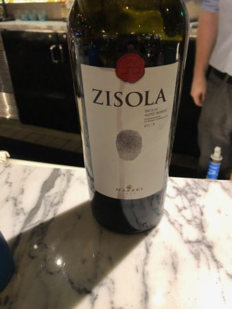 a bottle of wine on a marble table