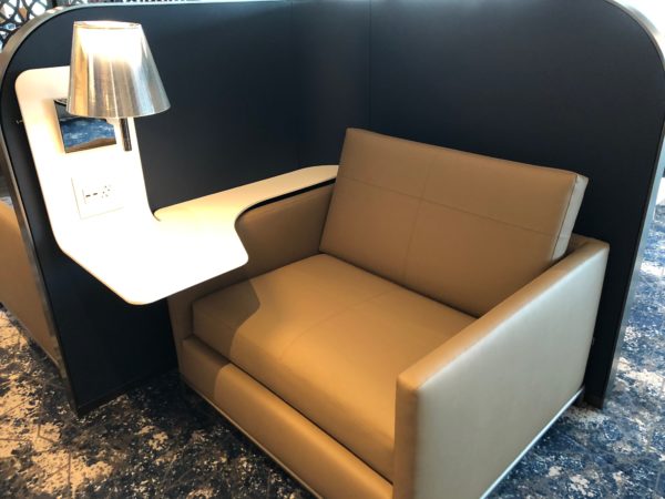 a chair with a table on the side