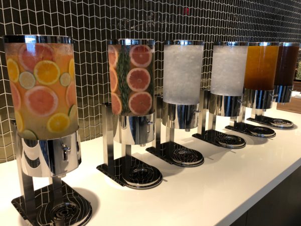 a row of juice dispensers